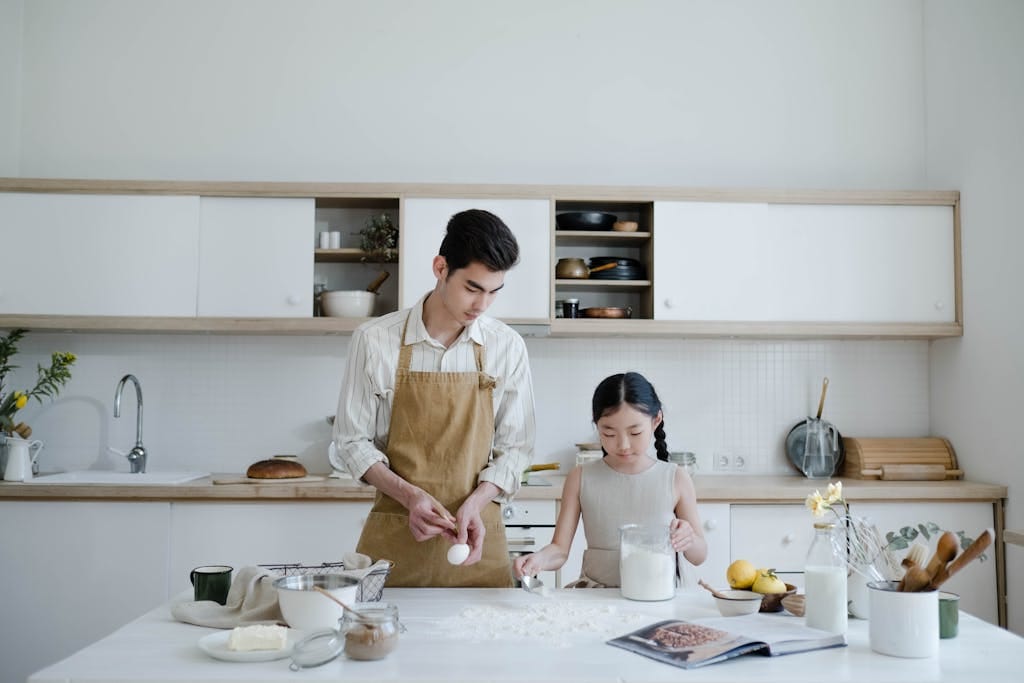 Father and Daughter Holding Baking Ingredient