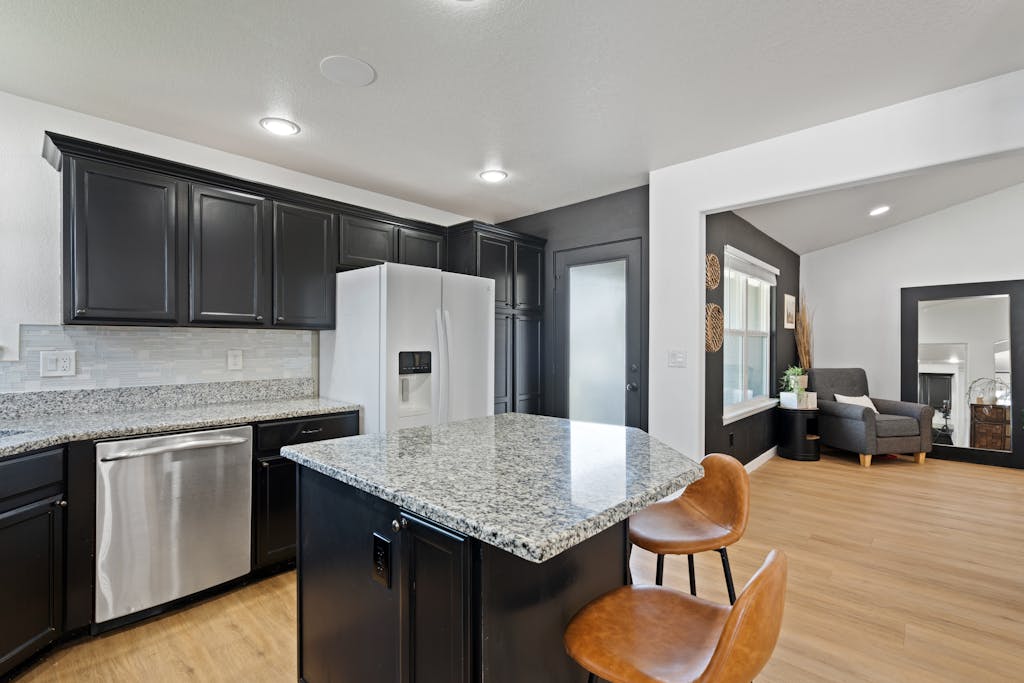 Sleek modern kitchen featuring granite countertops